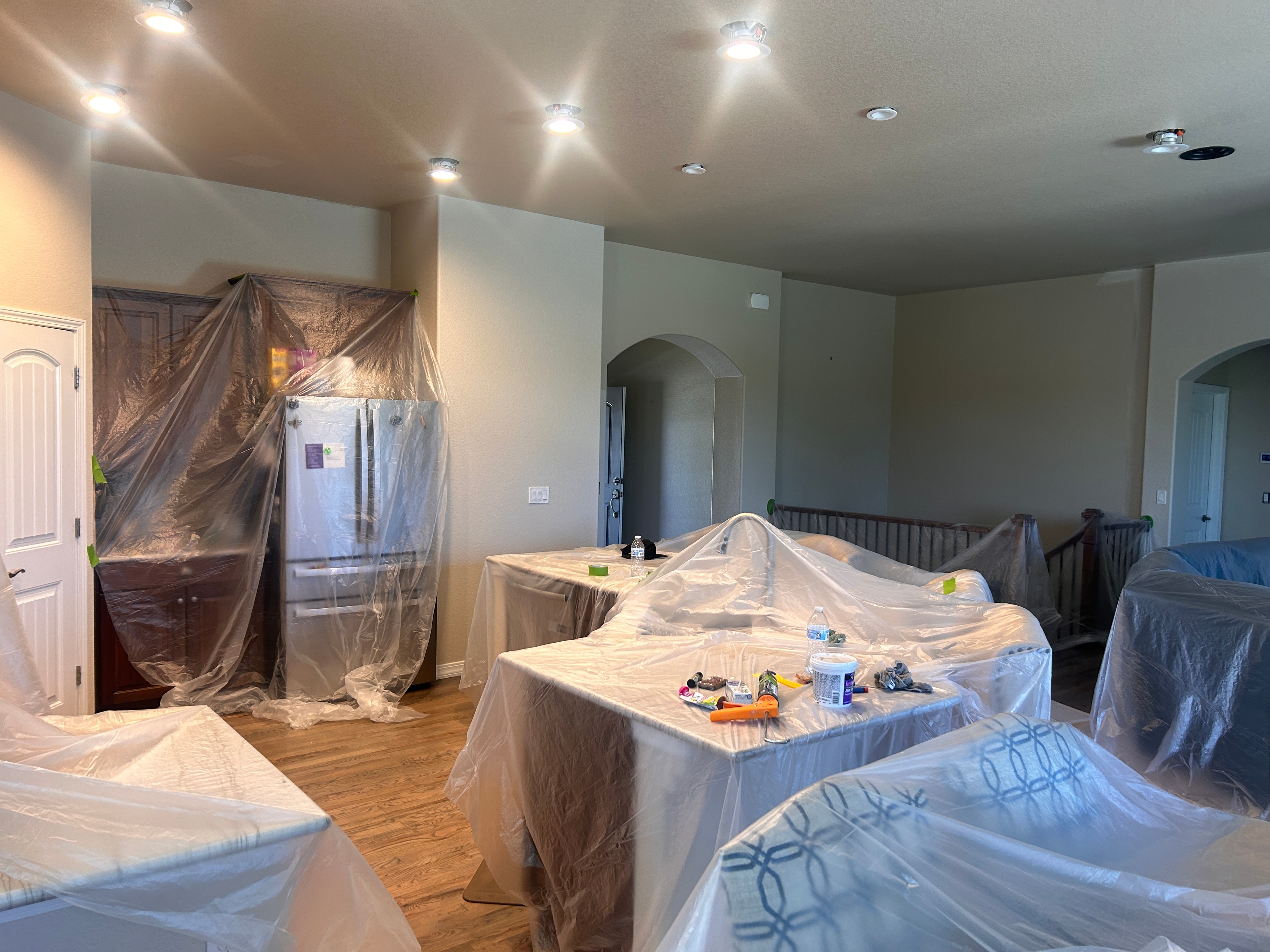Furniture and floors fully protected before painting begins